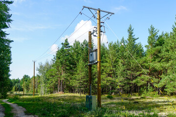 new modern overground wooden power line pole with electric transformer in rural area