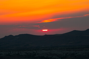 Sunset over the mountains. Sunset scene with silhouettes of mountains