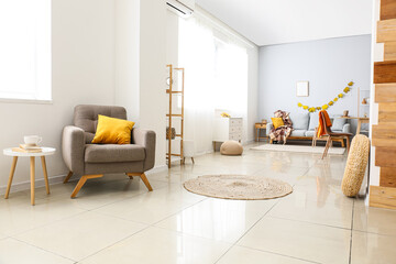 Interior of big living room with comfortable furniture and autumn decor