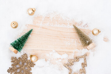 Christmas wood snow. Xmas board with old rustic wall, white frozen snowflake, golden balls and gift box. Winter wooden decoration background. Happy new year copy space.
