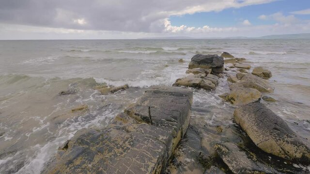 waves over rocks at the west coast of the Isle of Arran, Scotland, United Kingdom