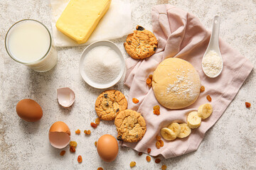 Fresh dough and ingredients for preparing homemade cookies on light background