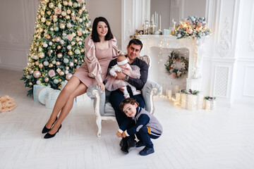Obraz na płótnie Canvas Happy family with children at home near the Christmas tree.