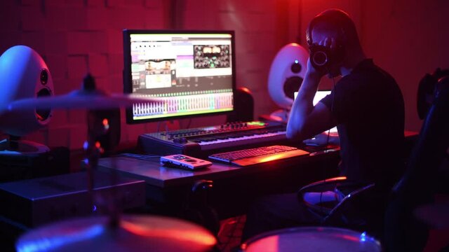 Sound engineer working and mixing music indoors in the studio
