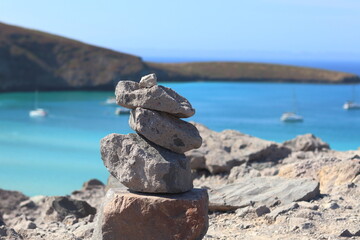 A mound of stones with the sea in the background