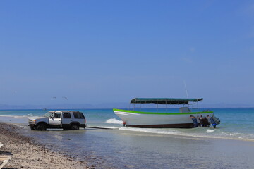 Fototapeta premium Trying to get a boat out of the water