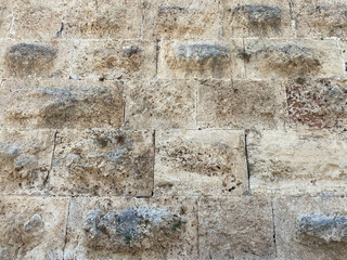 Texture of a stone wall made of large blocks. Elements of the building of ancient antiquity