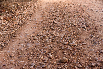 clay road with small red stones
