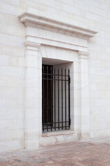 Fototapeta na wymiar A wrought-iron gate at a decorative entrance to a high stone house