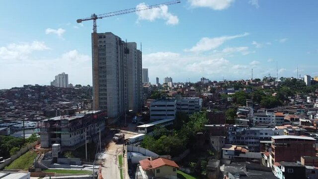 salvador, bahia, brazil - november 10, 2021: Crane is seen in a construction of a building next to a favela in the city of Salvador.