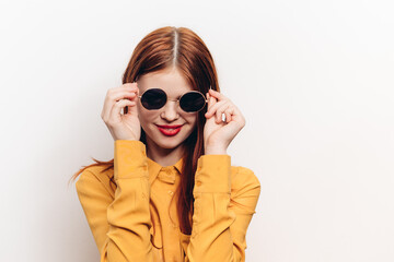 fashionable woman in yellow shirt sunglasses posing