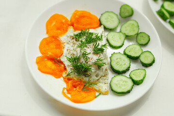 Soft focus, breakfast plate. Selective focus. Sliced cucumber, fried scrambled eggs close up.	