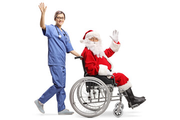 Full length profile shot of a female nurse pushing santa claus in a wheelchair and waving