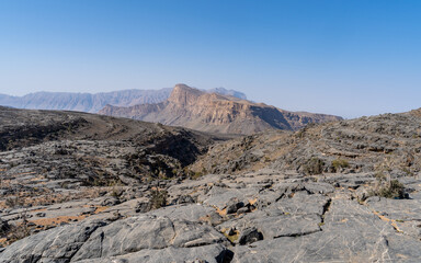 Rocky mountainous landscape overlooking the vast desert of Oman. 