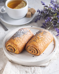 Homemade sweet rolls strudels with poppy seeds sprinkled with icing sugar and poppy seeds isolated