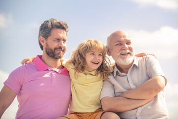 Fototapeta premium Men generation portrait of grandfather father and son child. Fathers day. Three men generation.