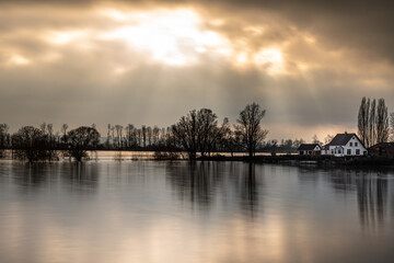 Sunlight above the flooded Rhine River, Spijk, Netherlands