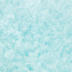 Texture of light blue artificial fur close up. Home decor and comfort concept.