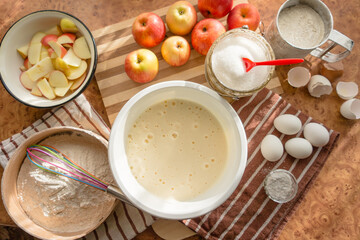 Prepared beaten eggs with a whisk, for a delicious and airy apple biscuit.