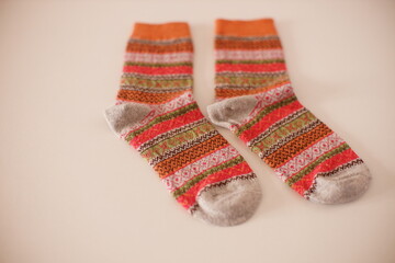a pair of new winter socks with a beautiful pattern on a white table