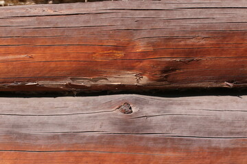 Background of horizontal hewed smooth painted wooden logs close up horizontal view. vintage