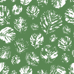 Seamless green watercolor background with white prints with silhouettes of leaves