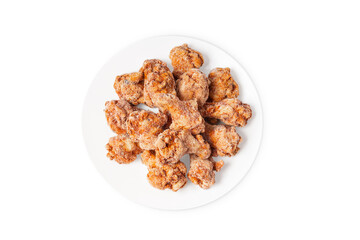 Fast food, convenience food.Frozen semi-cooked chicken wings on a white plate on a white background.