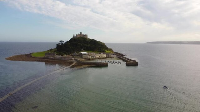 Speedboat heading towards St Michael's Mount near Penzance in Cornwall, England Drone Aerial View - Moving Forward