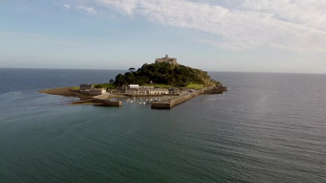 Speedboat heading towards St Michael's Mount near Penzance in Cornwall, England Drone Aerial View - Slow Orbit Right to Left Coast-side