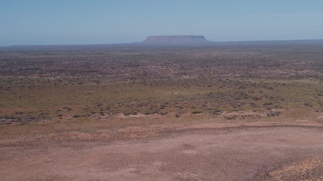 an aerial shot flying forward towards mount conner on a winter morning in the northern territory, australia