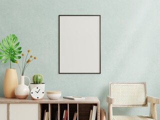 Poster mockup with vertical frame on empty dark blue wall in living room interior.