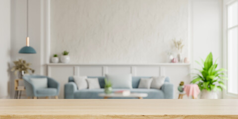 Fototapeta na wymiar Wood table top on blur living room have sofa and armchair.