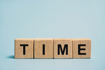 The word time on the wooden block The concept of time cannot be changed.