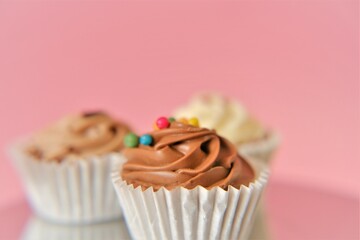 Cream cupcakes. White and black chocolate cakes .Chocolate dessert. Assorted sweet table. Sweets and desserts. Baked goods