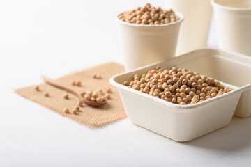 Soybeans in compostable cardboard boxes are eco-friendly concepts and are mainly used as a plant-based ingredient in vegetarian, healthy food.
