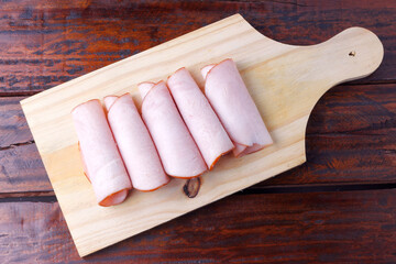 sliced cold smoked turkey breast over rustic wooden table - obrazy, fototapety, plakaty