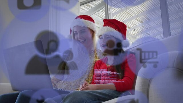 Animation of online shopping trolley icons over caucasian mother and daughter at christmas