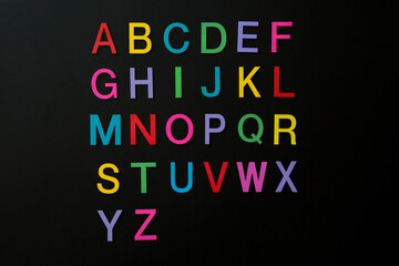 Colorful wooden english letters A-Z on black background