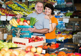 Portrait of family couple who is standing in the grocery shop