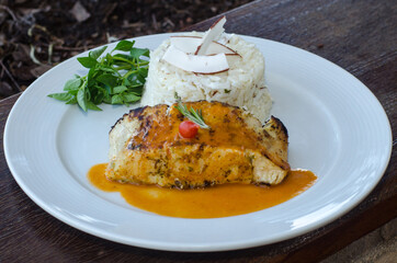 Salmon with sauce, rice and herbs