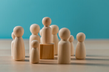 Leadership Concept, teamwork, business strategy, HR, Wooden peg dolls puzzle on wooden background.