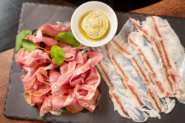Tigelle with culatello and lardo, served with fresh baked biscuits.