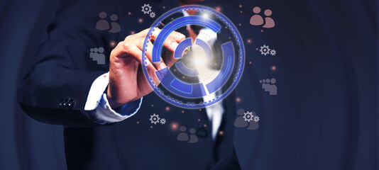 A young businessman uses the darts embroidered onto the tablet abstract to set goals to invest in his corporate business in his planning for the coming year.