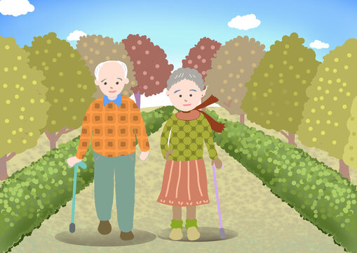 老夫婦が公園を散歩している秋の風景
