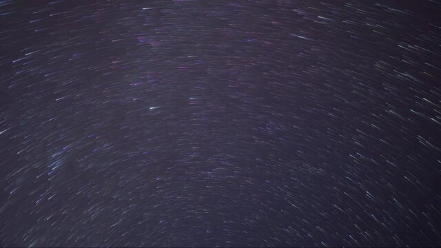 Beautiful Time lapse star trails revolving around the north star with Geminids meteor shower