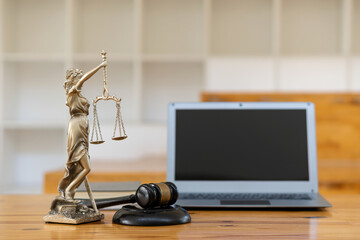 statue of justice goddess of justice and judge's hammer concept with a laptop, a judicial process background, and a professional lawyer. the scale of justice legal concept picture