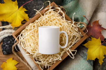 White coffee mug mockup with gift box and maple leaves