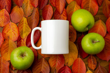 White coffee mug mockup with red fall leaves and green apples