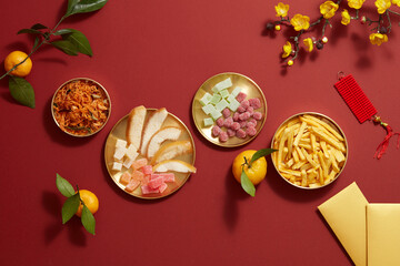 Tet holiday with mandarin orange candy jam , fried potato , flower and ang pao biscuit in golden...