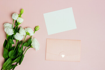 A bouquet of white roses and pink letter over the pink background.